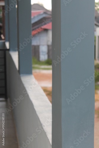 Wallpaper Mural Close up of modern grey concrete pillars on a balcony with a blurred suburban background. Abstract architectural detail focusing on clean lines, minimalism, and contemporary construction materials. Torontodigital.ca