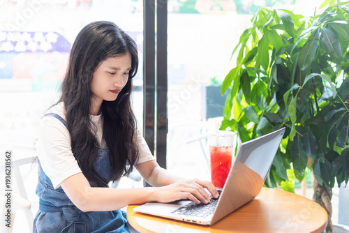 A Chinese beauty drinking milk tea while working in a milk tea shop