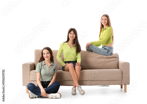 Young women sitting on sofa...