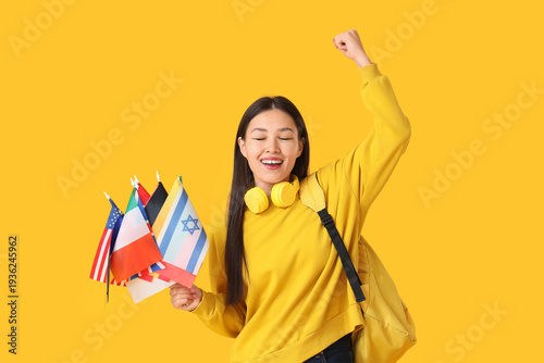 Happy Asian woman with flag...