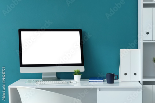 Workplace with blank comput...