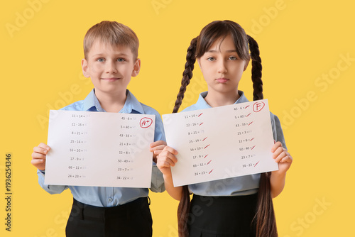 Little pupils holding paper...