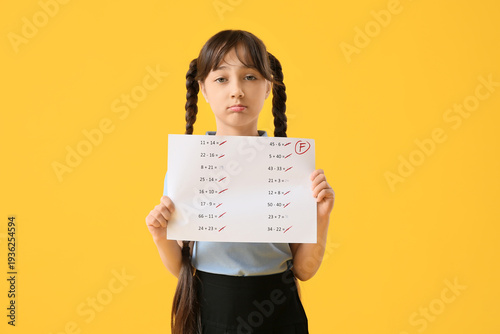 Sad schoolgirl holding bad ...