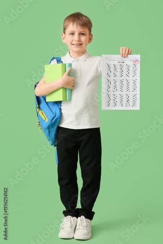 Happy schoolboy with backpa...