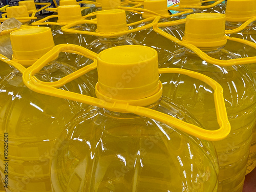 A row of yellow bottles with yellow lids