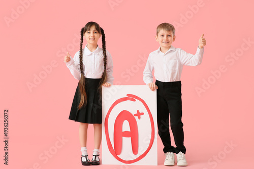 Happy little pupils holding...