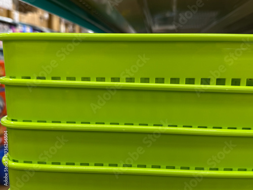 A stack of green plastic containers with holes in them