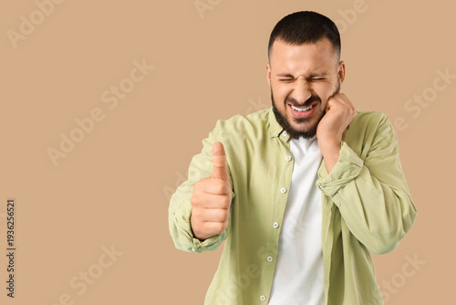 Young man with taped finger...
