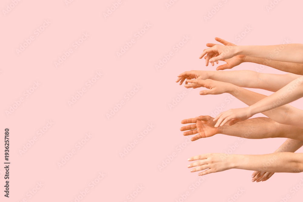 Naklejka premium Many hands on pink background