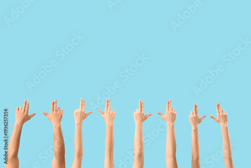 Many hands showing gun gest...