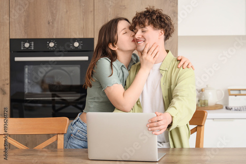 Young woman kissing her boy...