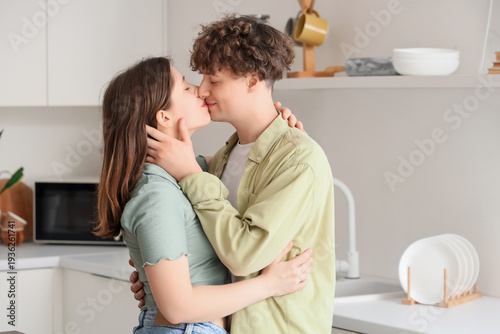 Young couple kissing in kit...