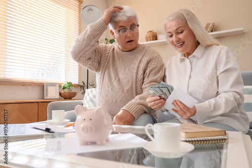 Surprised senior couple wit...