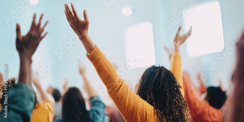 Diverse group of people worshipping at a church service with raised hands in an indoor sanctuary setting, ideal for faith-based marketing and communal prayer branding