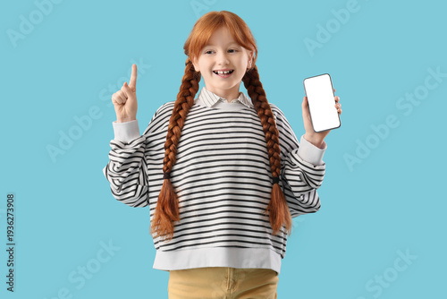 Cute ginger girl holding mo...