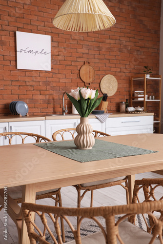 Vase with tulips on dining ...
