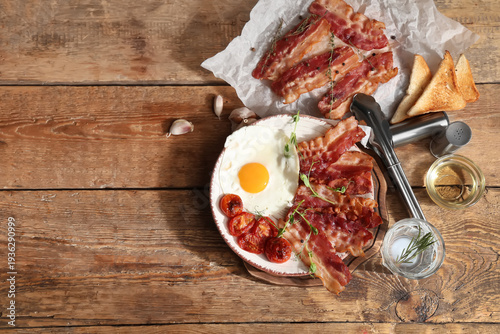 Plate with fried egg and ba...