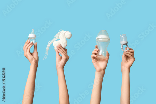 Female hands with baby bott...