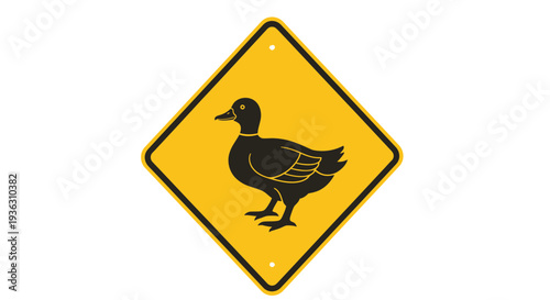 A black duck on a yellow warning sign viewed from a driver's perspective on a road