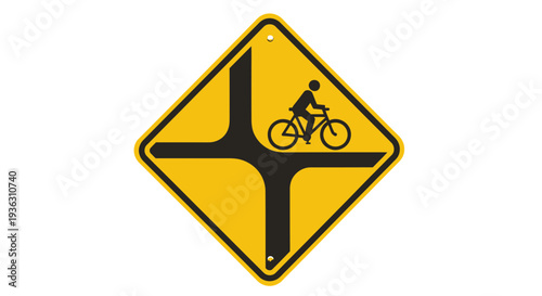 A cyclist riding through a four-way intersection depicted on a yellow warning sign