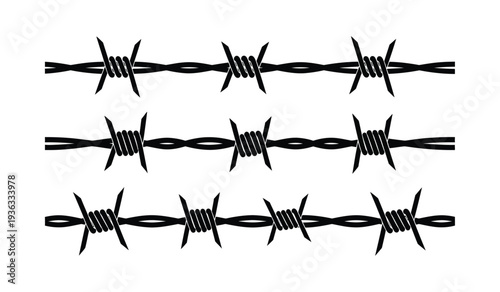 Barbed wire fence with sharp metal spikes