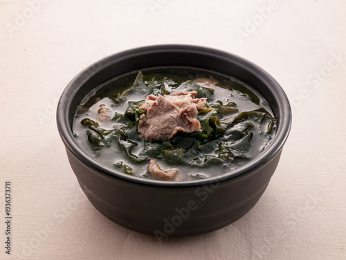 Korean cuisine : Traditional seaweed soup with beef served in a black clay pot.