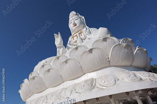 Tableau sur toile Chiang Rai, Thailand - November 29 2025 : External view of the large white Guan Yim or Goddess of Mercy statue at Wat Huay Pla Kang, Chiang Rai, Thailand