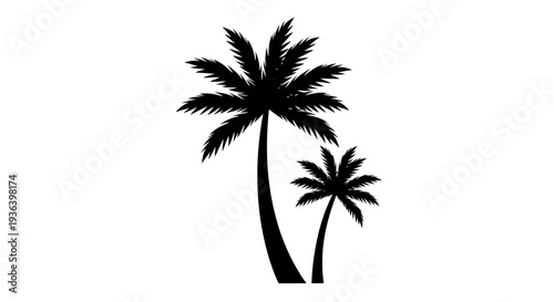 Two palm trees stand tall on a sunny tropical beach at sunset