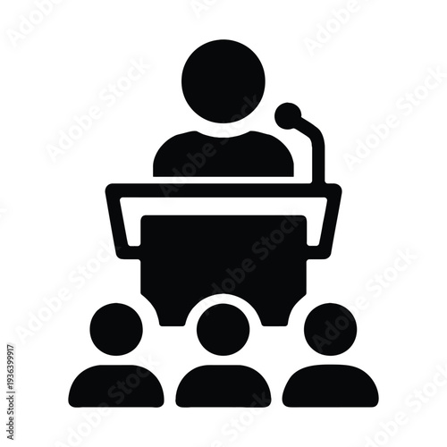 Speaker giving speech from podium with microphone to audience in conference hall