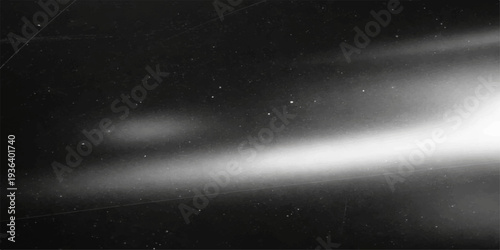 A vast nebula of bright stars and dark clouds glows across the starry night sky of a deep blue galaxy in the infinite outer space cosmos