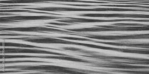 Abstract ripple pattern of black and white fabric texture blending with a wet dark leather surface reflecting liquid waves of light on a deep ocean nature background