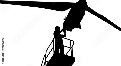 Worker on lift repairing large wind turbine silhouette