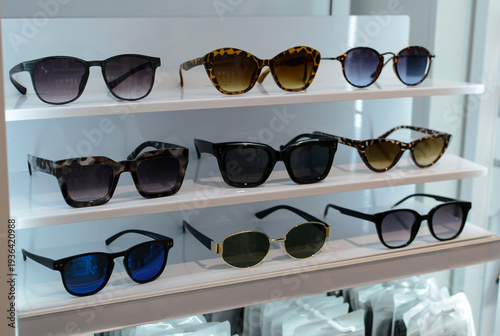Various stylish sunglasses on display in a store. Fashion accessory.
