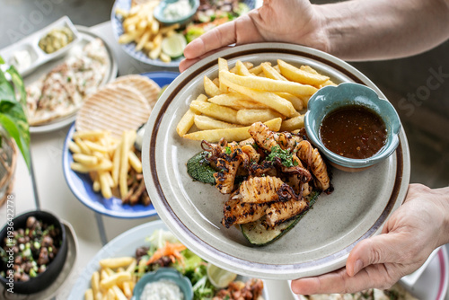 Wallpaper Mural mediterranean style grilled squid with escabeche sauce and fries on white table at ibiza spain restaurant Torontodigital.ca