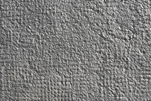 фотографія A close up shot of a rough wall surface covered in shiny silver metallic paint r