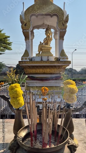 The smoke from incense offered to Brahma, along with marigold flowers, is a sign of respect and worship.