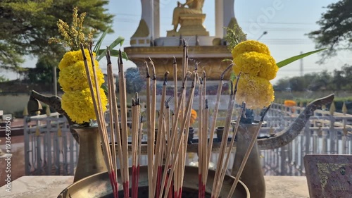 The smoke from incense offered to Brahma, along with marigold flowers, is a sign of respect and worship.