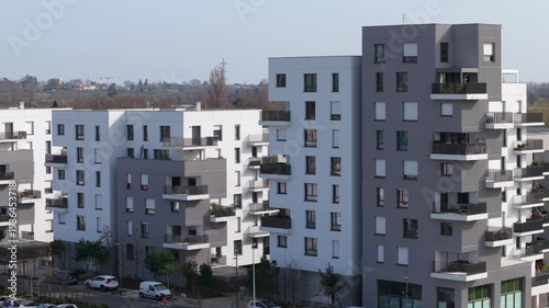 Beautiful aerial overview of large apartment buildings in a new suburban neighborhood in Eysines, Gironde, France on a sunny day.. High quality 4k footage