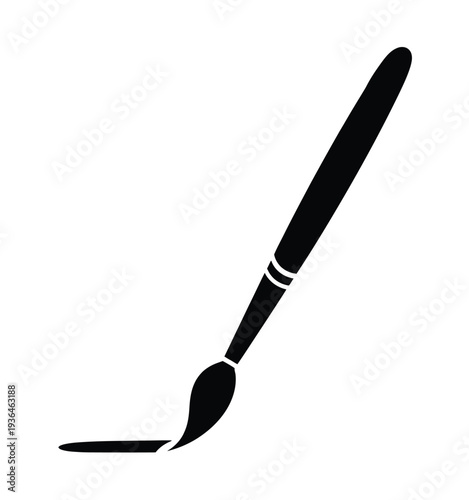 Black paintbrush with wet tip on white background painting