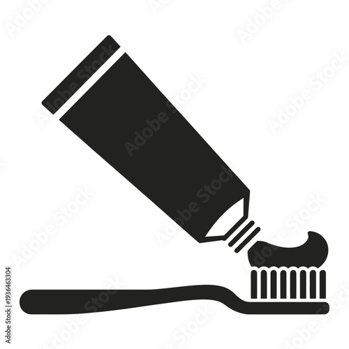 Black toothpaste tube squeezing onto toothbrush white