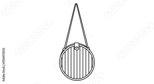 Stylish round straw handbag with a long shoulder strap isolated on a white background for summer fashion and travel style.