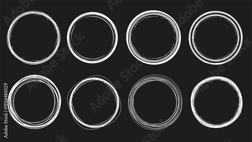 Set of eight hand-drawn white circular frames and borders with a sketchy textured look isolated on a dark background for creative designs.