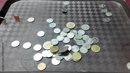 Many Thai baht coins of various denominations fell to the ground.