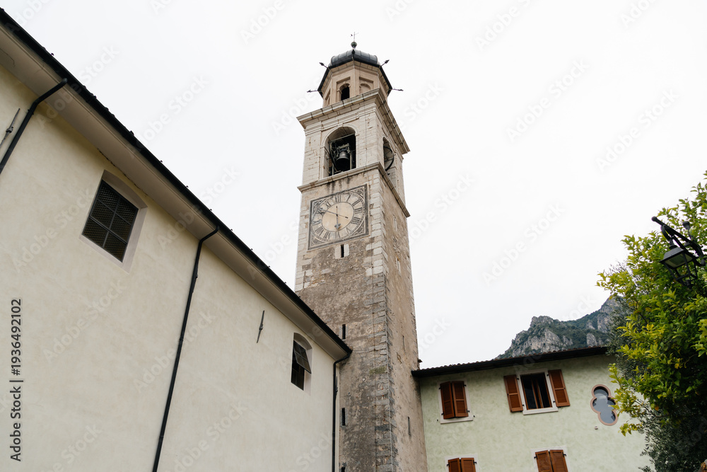 custom made wallpaper toronto digitalHistoric clock tower in Limone sul Garda, Italy, against a cloudy sky.