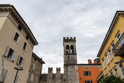 Wallpaper Mural Riva del Garda historic tower and colorful buildings under a cloudy sky. Torontodigital.ca