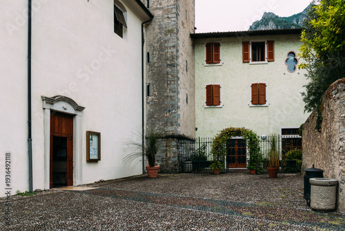 Wallpaper Mural Picturesque church courtyard in Limone sul Garda, Italy, with traditional architecture. Torontodigital.ca