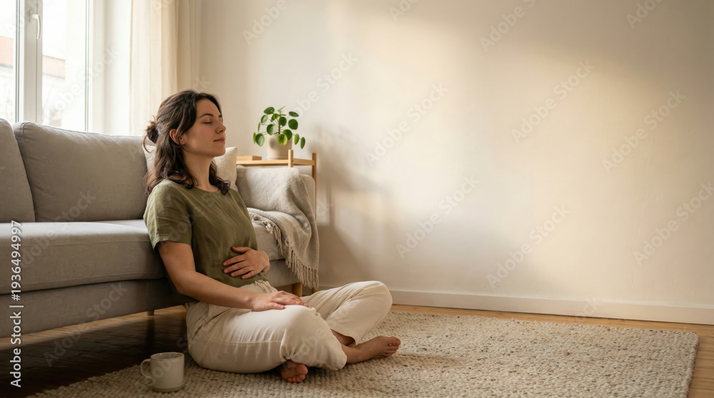 Obraz premium Woman meditating cross-legged on rug at home