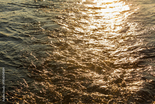 Churned up water with the sun reflecting off the surface.