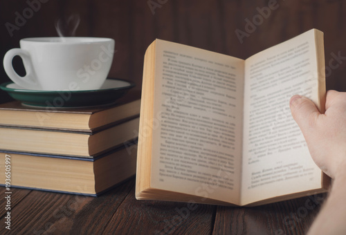 Book reading with coffee cup and heart shaped steam cozy morning education concept