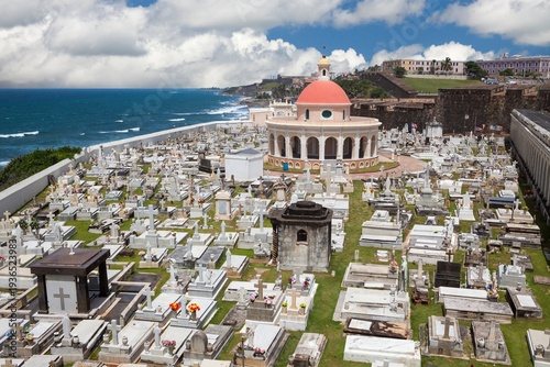 Cementerio de Santa Maria Magdalena de Pazzis rests beside the Atlantic Ocean in Old San Juan, Puerto Rico - a historic cemetery known for its neoclassical chapel with red dome and oceanfront setting.